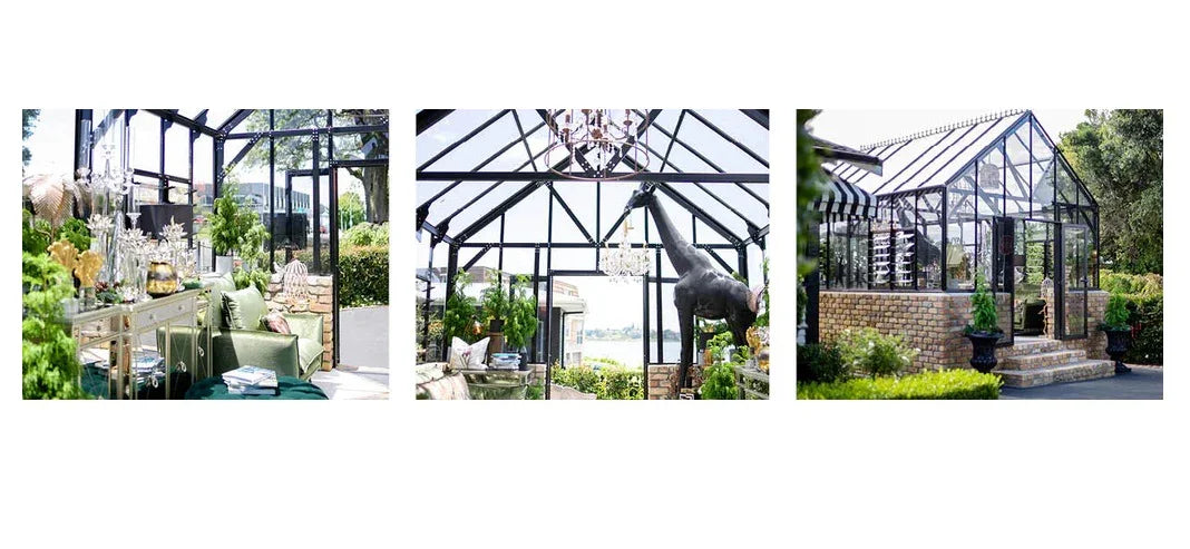 12ft Rosie Elite greenhouse with glass panels, black frame, brick base, and lush garden surroundings